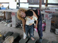 Laury Dizengremel and a Honduran child creating two of the footprints designs