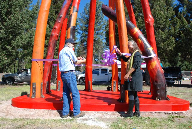 Laury Dizengremel stands with Chief Victor Charlo, who cut the ribbon at the opening ceremony for Log Henge - a timber circle on the edge of Highway 83, in downtown Seeley Lake (Montana, USA)