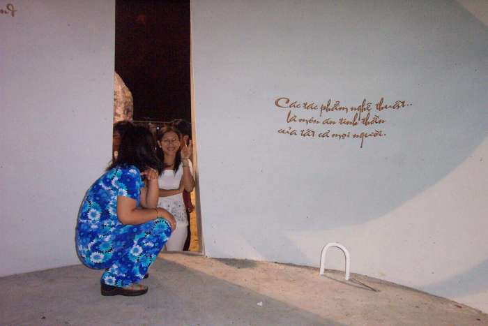 A viewer inside the sculpture at night - the two quotes were written in Vietnamese and in English